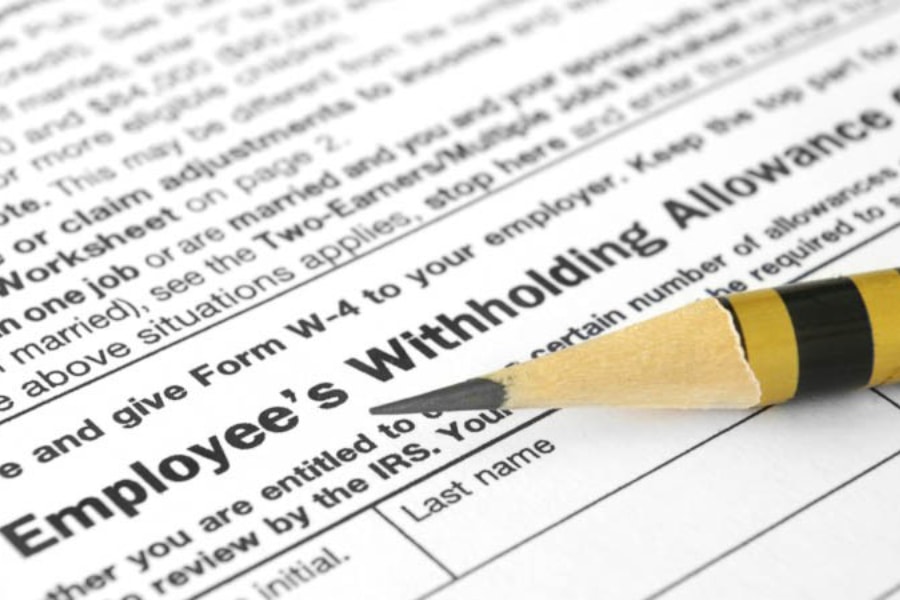 A sharp pencil lay ready to fill out an Employee's Wilthholding Allowance form
